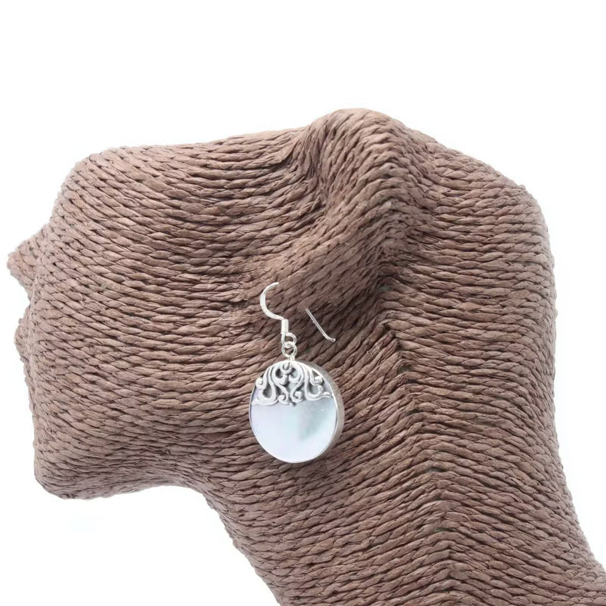 Mother of Pearl disc earrings being held, artisan silver jewellery gift packaging