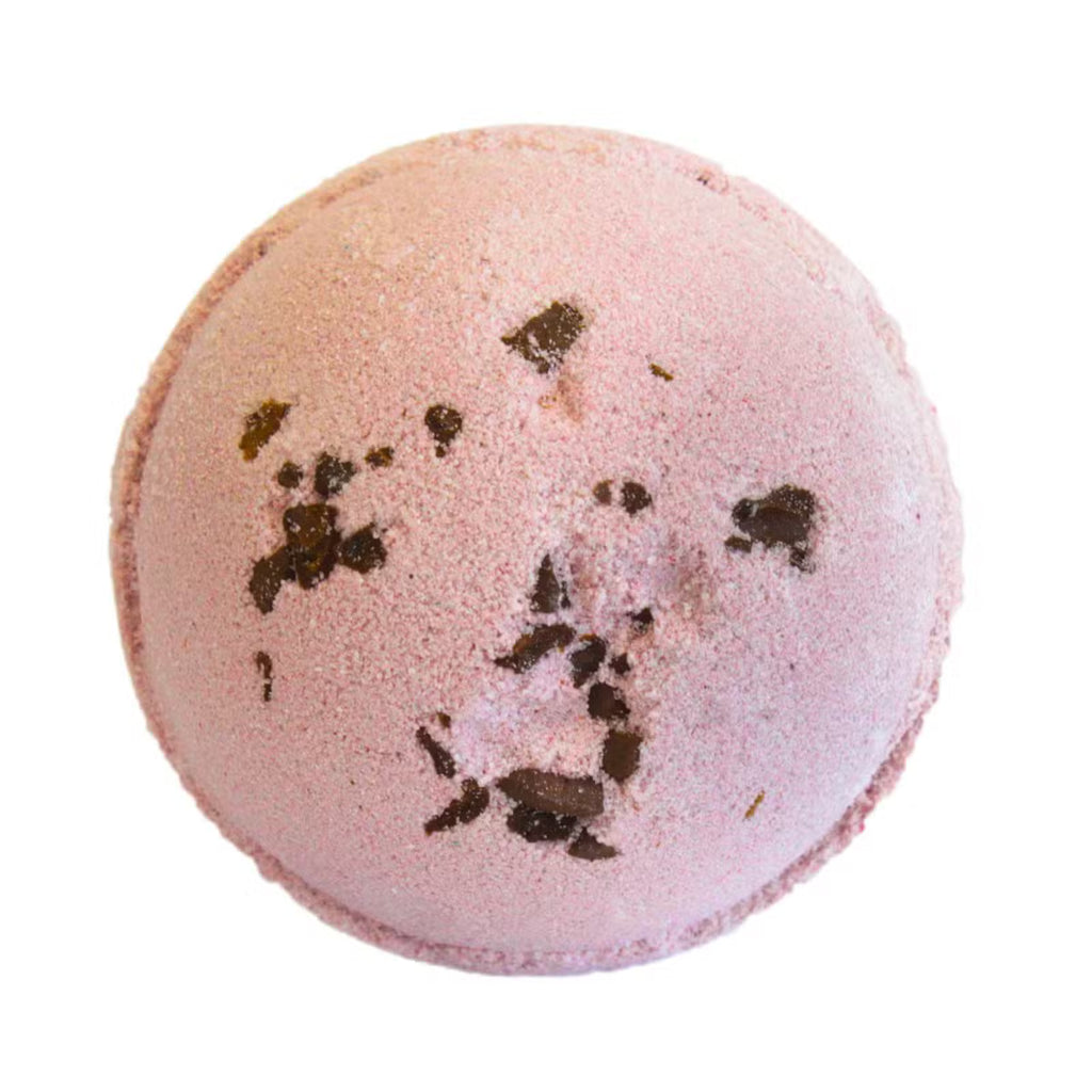 Pink Espresso Martini bath bomb with dark coffee flecks on white background
