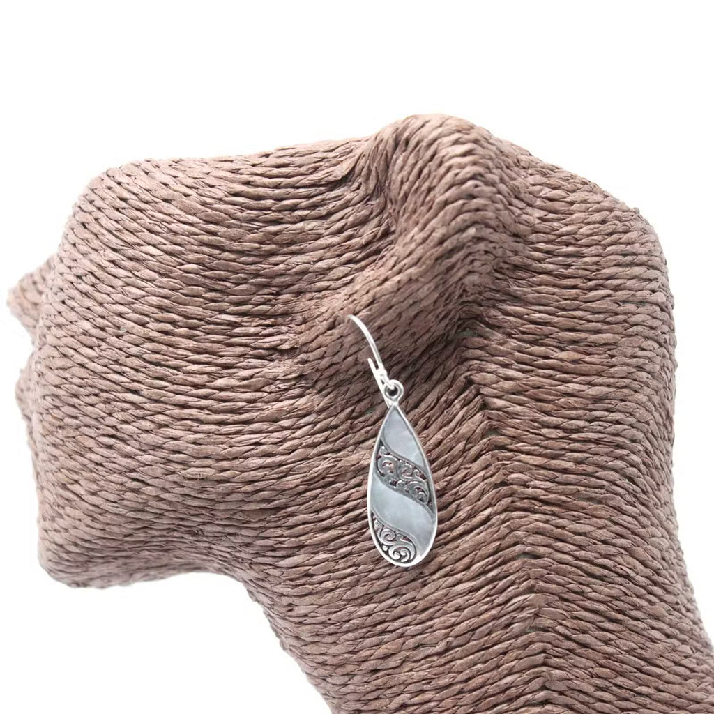 Mother of Pearl teardrop earrings being held, silver artisan jewellery gift