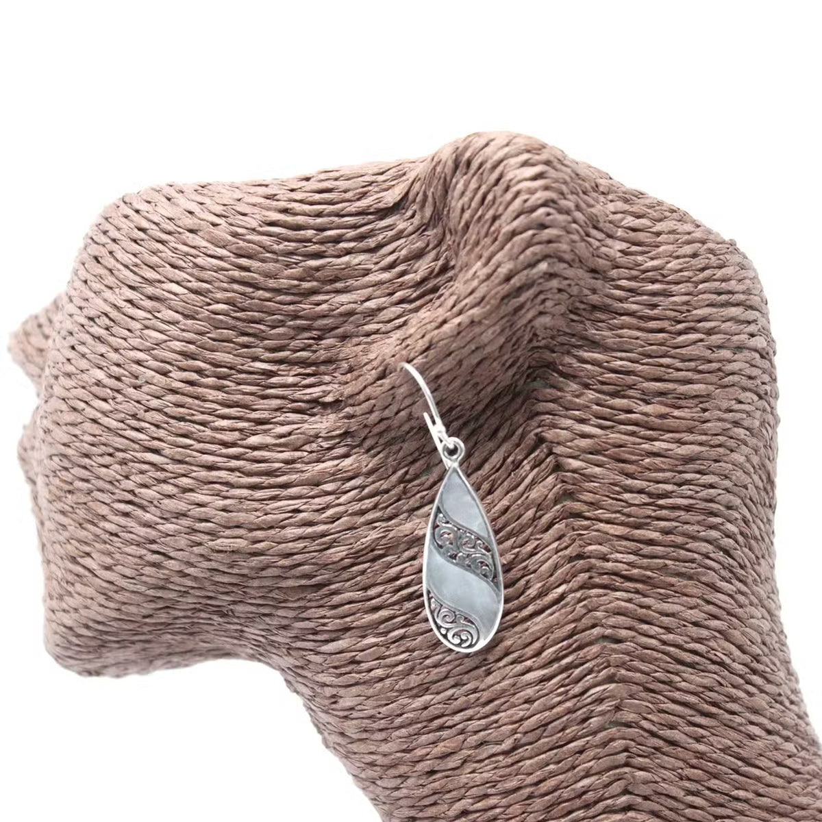 Mother of Pearl teardrop earrings being held, silver artisan jewellery gift