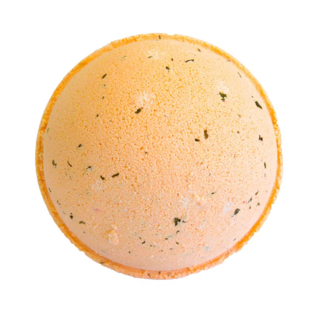 Peach and orange mojito with lime bath bomb with mint herb flecks on white background