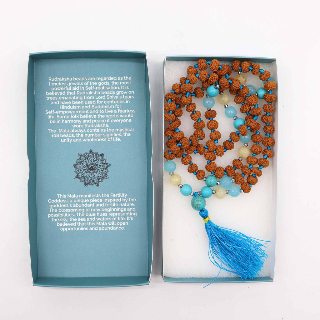 Rudraksha mala necklace displayed inside an open blue gift box⠋
