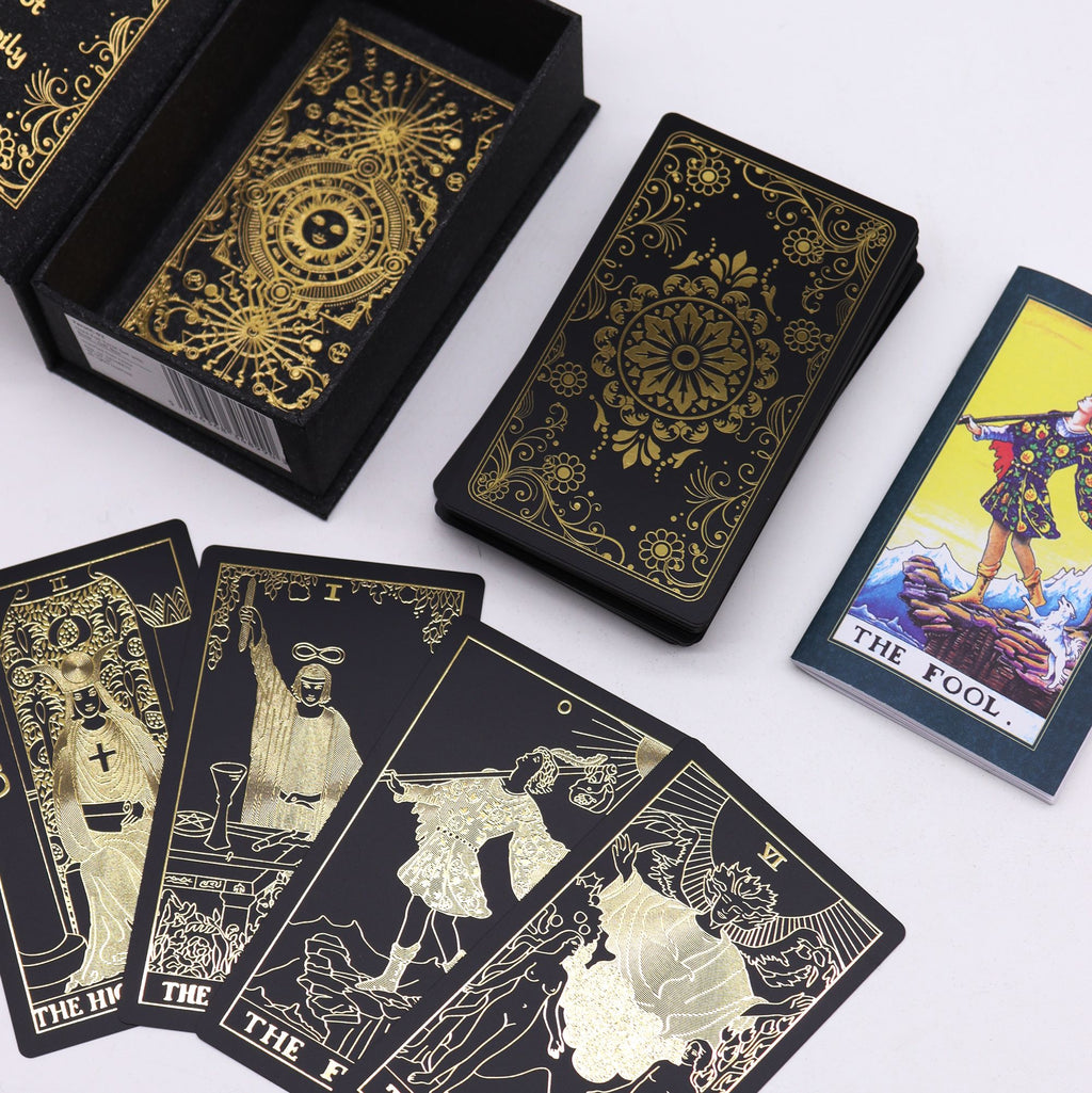 old Foil Tarot Set 78 black and gold cards fanned out with guidebook and open gift box UK