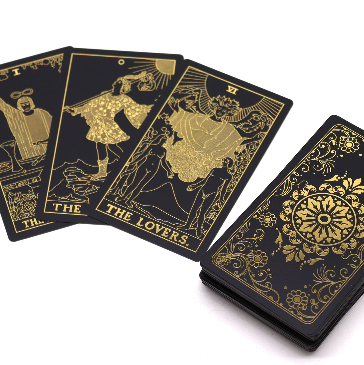 Gold foil tarot cards showing The Lovers fanned out with black gold floral card backs UK