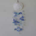 Copis and glass drop wind chime blue and white — full product view hanging against white wall with capiz shell top