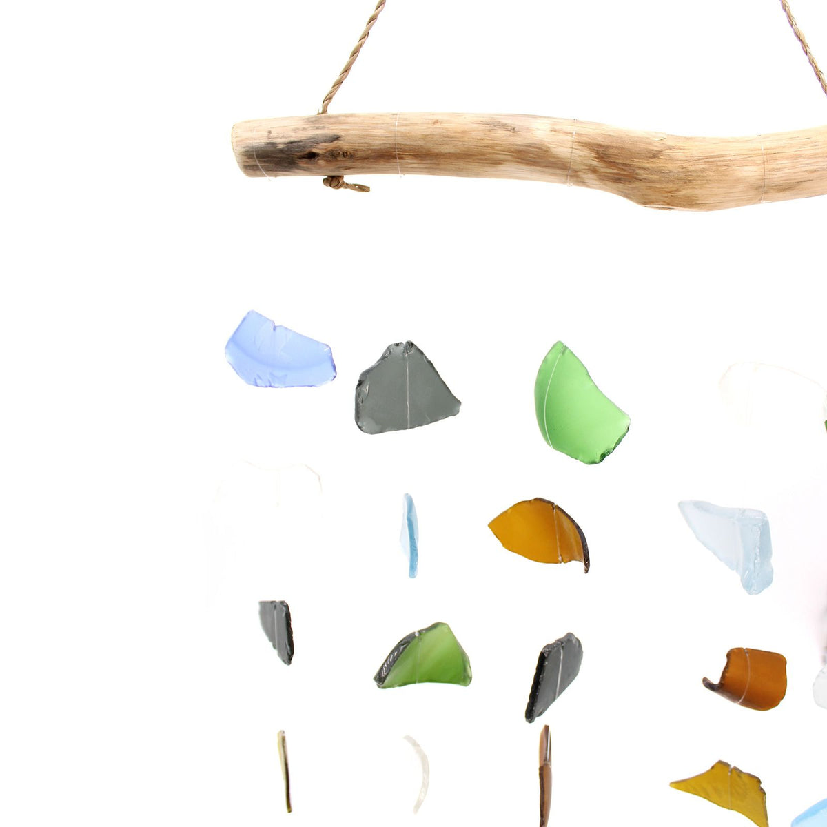 Five string multi colour glass wind chime hanging from natural driftwood bar