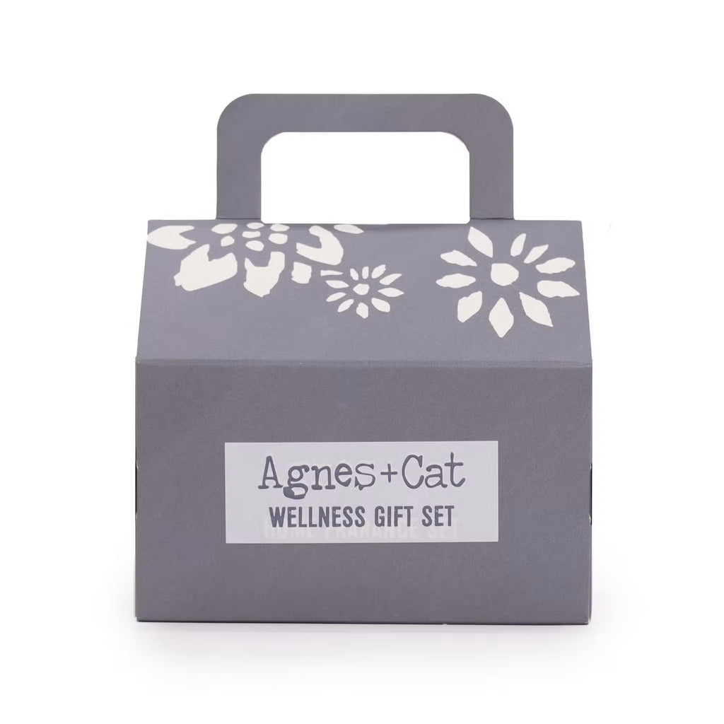 Agnes and Cat grey house-shaped wellness gift set box with white floral cut-out design and handle