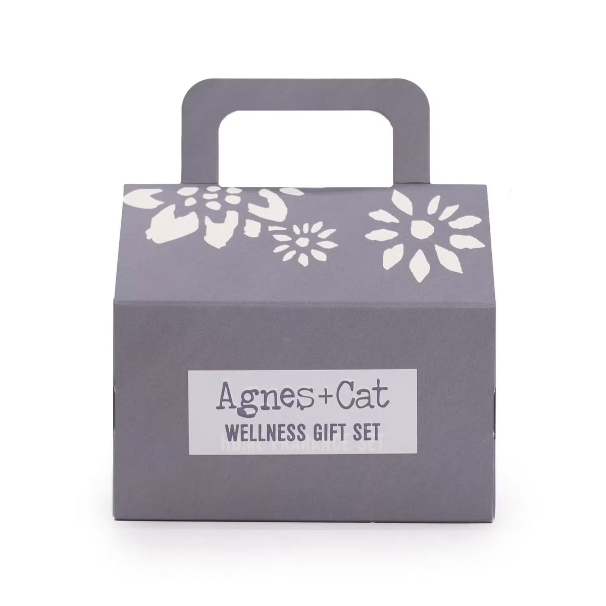 Agnes and Cat grey house-shaped wellness gift set box with white floral cut-out design and handle