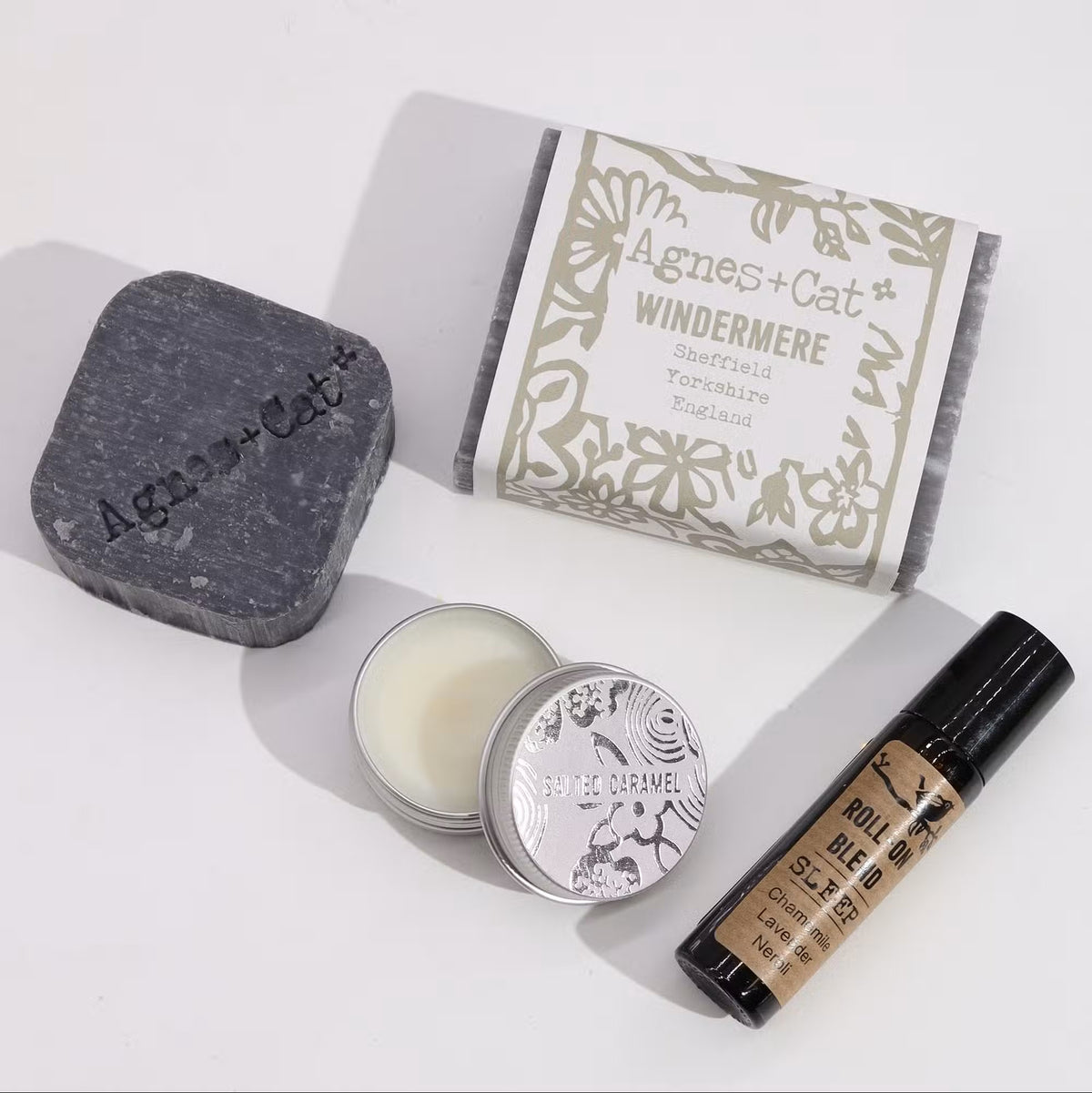 Agnes and Cat Windermere charcoal soap bar, salted caramel lip balm tin and chamomile lavender neroli sleep roll-on essential oil blend